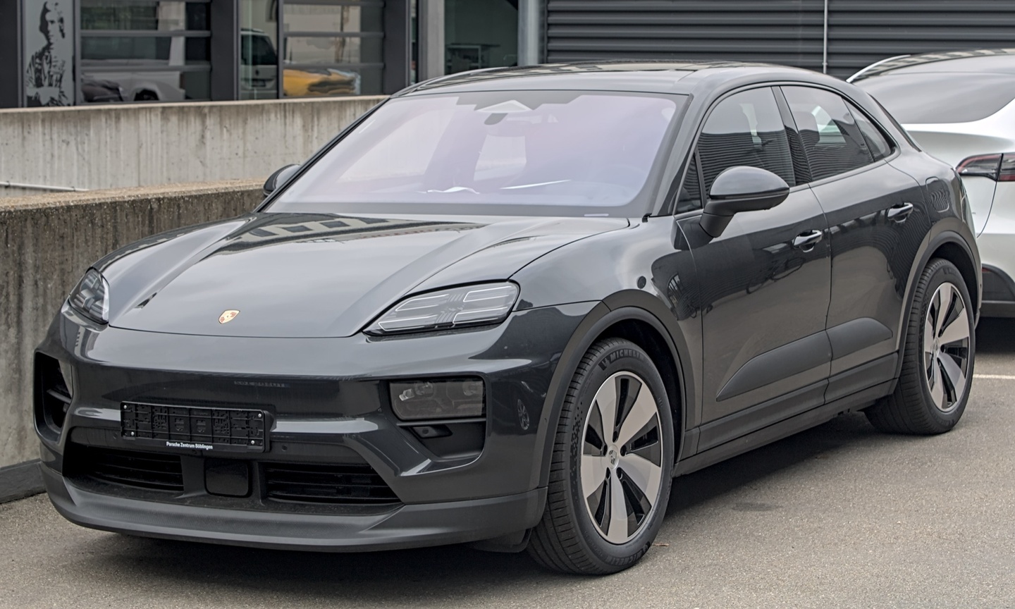 Before: Porsche Macan EV on outdoor dealership lot